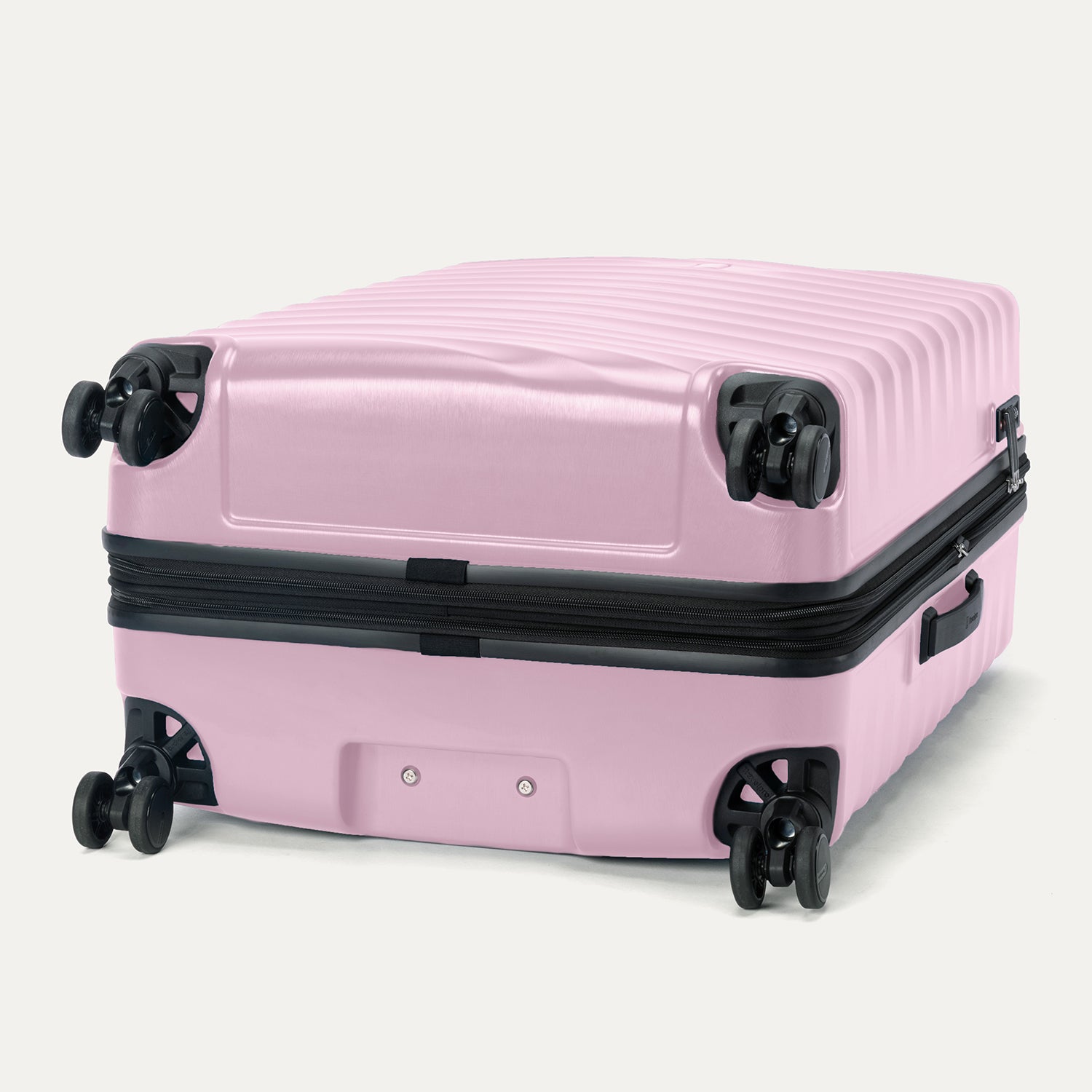 Bottom view of Travelpro Maxlite Air V2 Spinner in Orchid Pink, featuring dual spinner wheels and visible side carry handle.