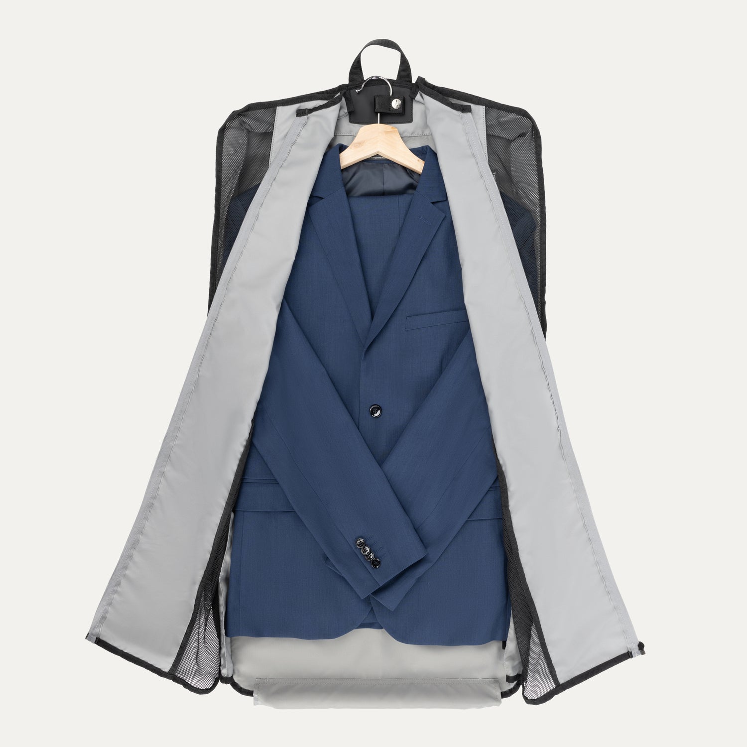 Travelpro® Essentials™ Drop-in Garment Sleeve opened to reveal a neatly packed suit