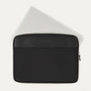 Travelpro® Essentials™ 13"/14" Laptop Sleeve in Black, shown with a laptop partially inserted to highlight its slim, protective fit, featuring a leather-accented top panel and secure side zipper closure.