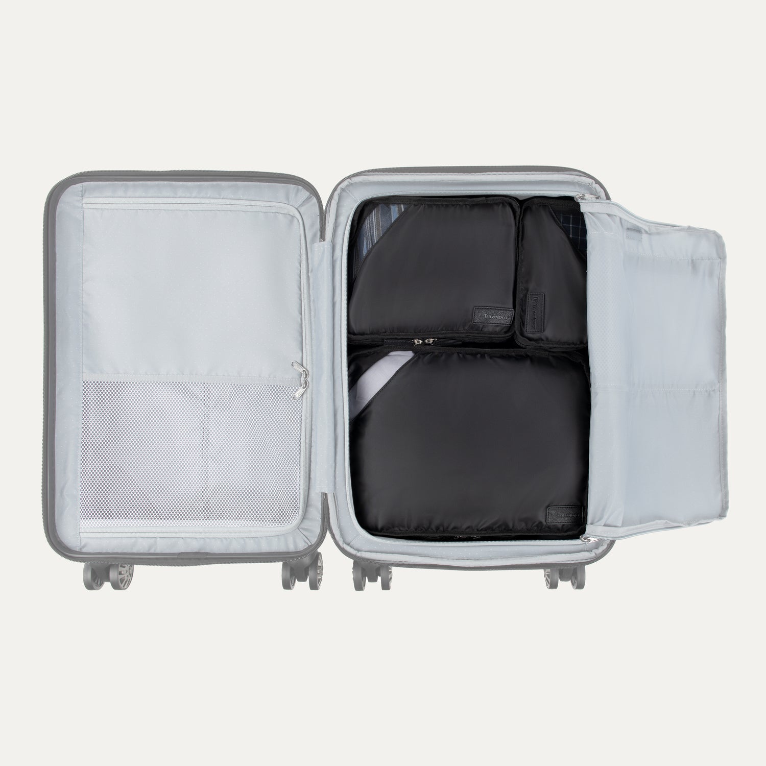 Top view of Travelpro Essentials 3 Pack Packing Cube Set in BLACK, efficiently arranged inside an open hardside carry-on.