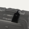Travelpro Essentials Leather Luggage Tag in Black, attached to suitcase handle with secure buckle strap.