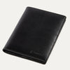 A black leather passport cover with the Travelpro brand logo visible on the lower side.