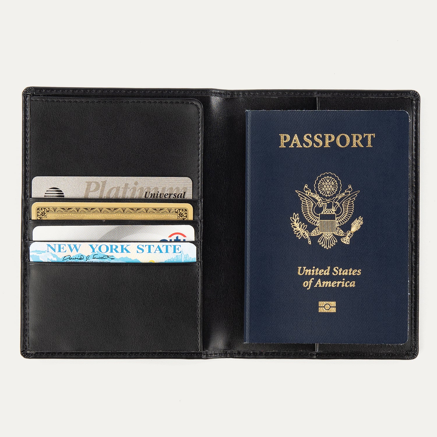 Open black Travelpro® passport cover displaying a passport on the right side and multiple cards stored in the left card slots