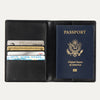 Open black Travelpro® passport cover displaying a passport on the right side and multiple cards stored in the left card slots