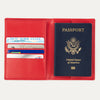 Open red Travelpro® leather passport cover displaying multiple card slots on the left and a passport pocket on the right, shown holding passports and cards.