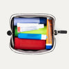 Top view of the Travelpro MaxAccess Cubes™ Small Organizer in black, unzipped and filled with toiletries