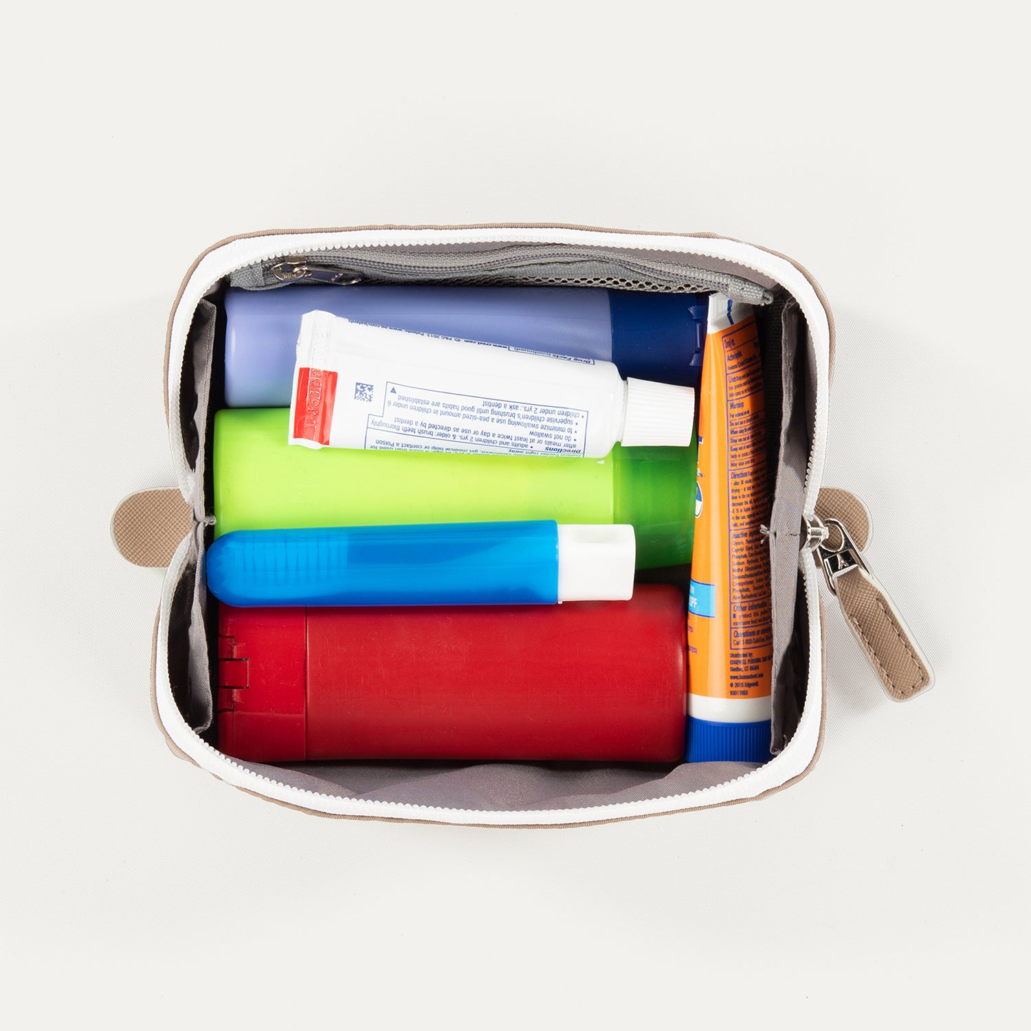 Top view of the Travelpro MaxAccess Cubes™ Small Organizer in khaki, unzipped and packed with assorted toiletries
