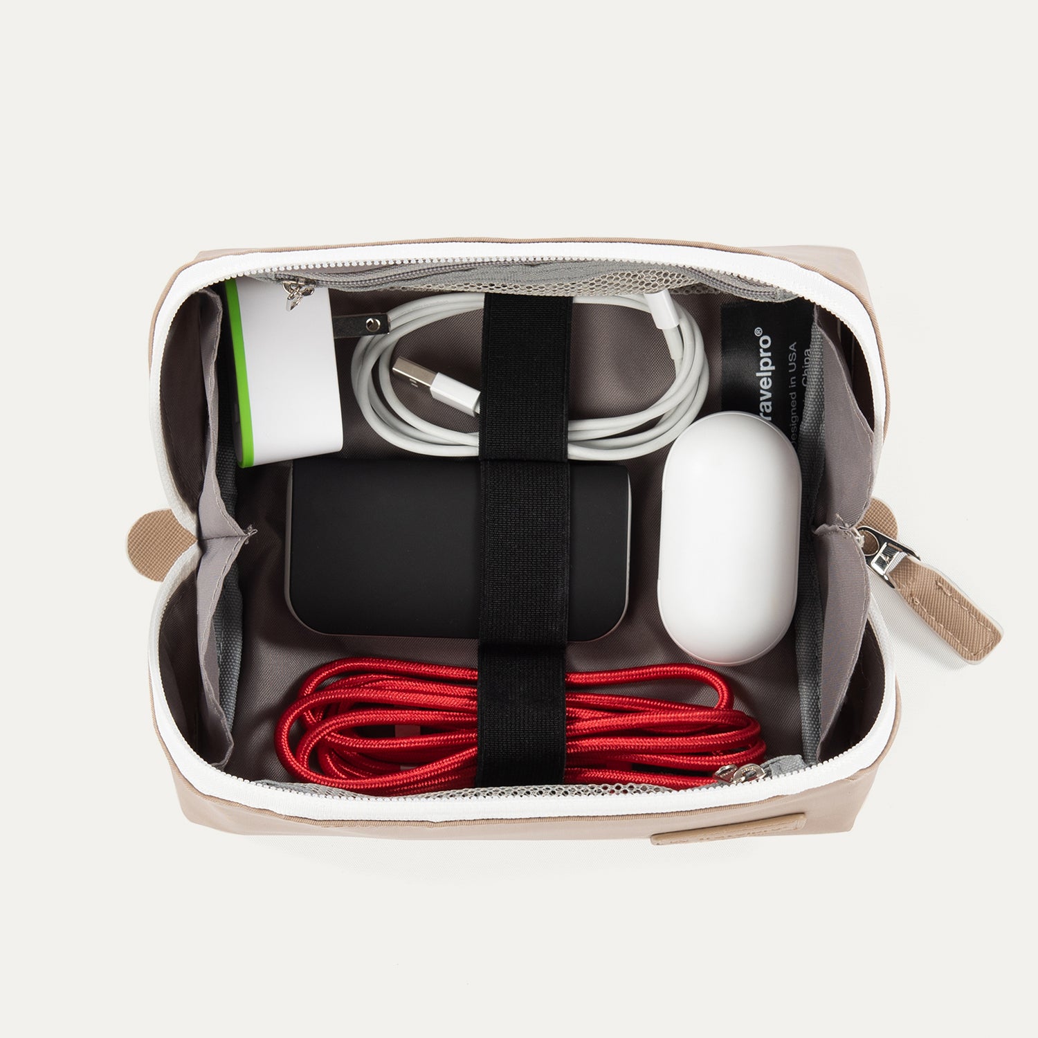 Top view of the Travelpro MaxAccess Cubes™ Large Organizer in khaki with a white zipper, neatly packed with electronics and secured with interior elastic straps.