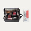 A toiletry organizer bag open, displaying various compartments and pockets filled with grooming supplies, with an exterior zippered pocket containing additional travel-sized items.