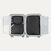 Top view of Travelpro Essentials 3 Pack Expandable/Compressible Packing Cube Set (M/L/XL) in BLACK, with all three cubes packed inside suitcase.