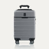 Front view of T+L Compact Carry-On Spinner in Whistler Grey, featuring a smooth telescoping handle and grooved shell design.