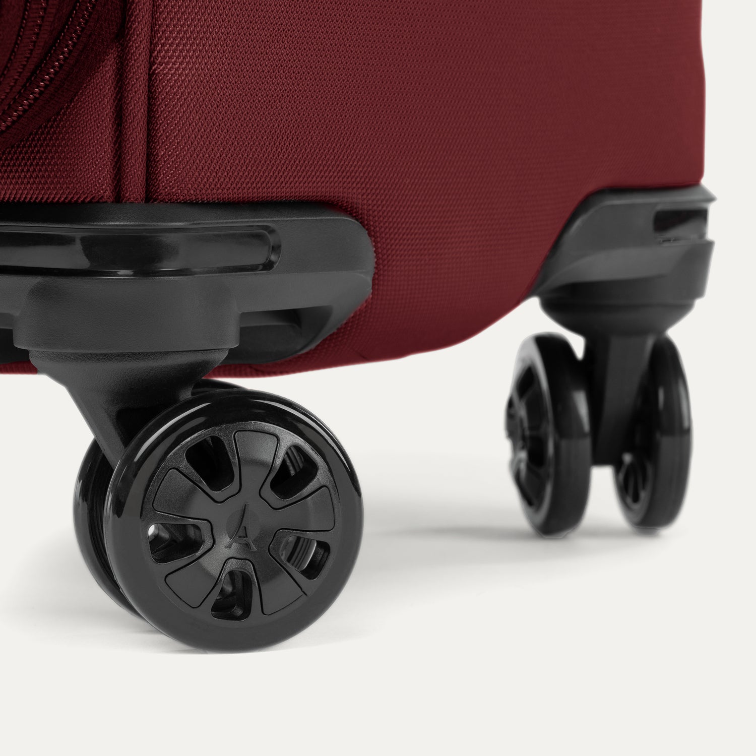 Red suitcase with black wheels on a white background