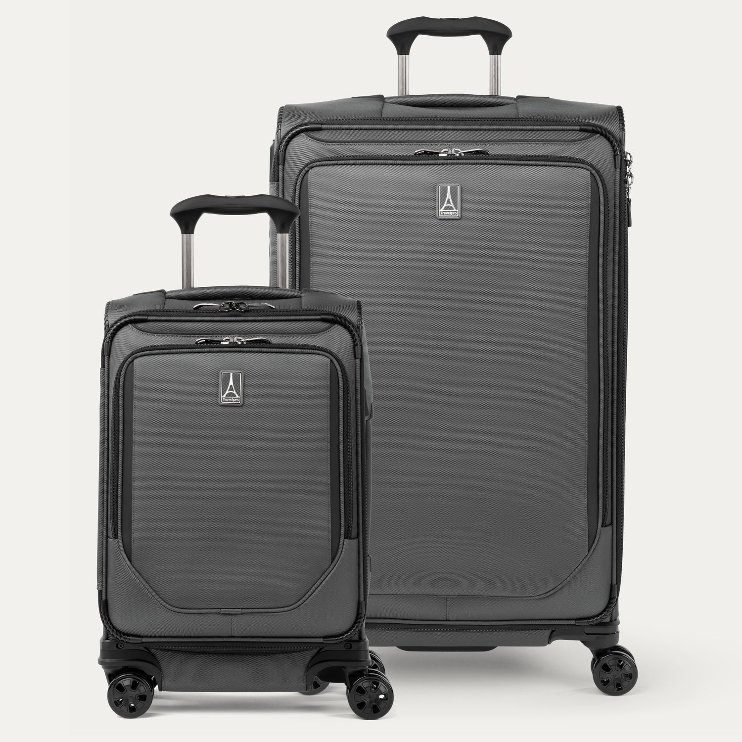 A set of two gray spinner suitcases, one carry-on size and one check-in size on a white background