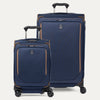 A set of two blue spinner suitcases, one carry-on size and one check-in size, with brown accents on a white background