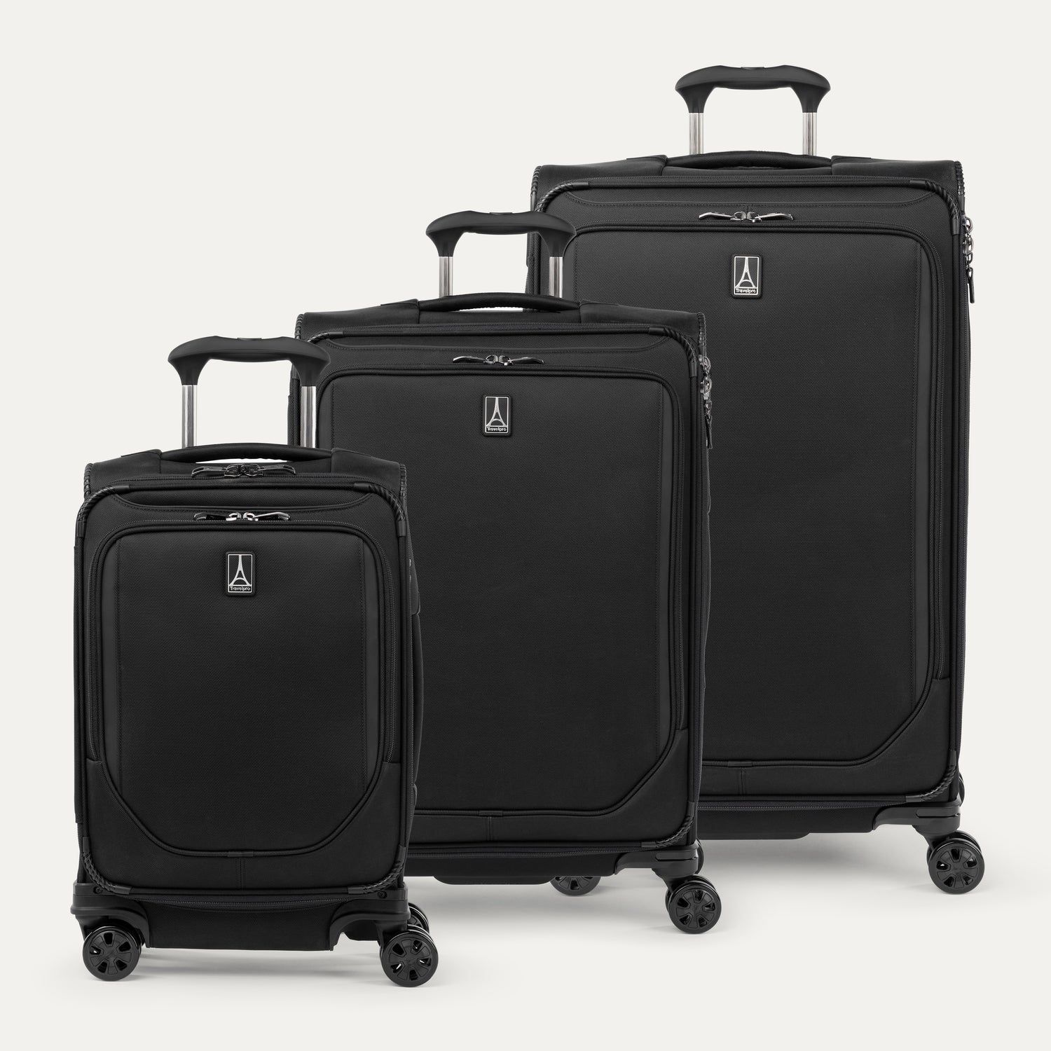 A set of three black spinner suitcases, including a carry-on size, medium size, and large size, aligned in a row with telescopic handles extended.