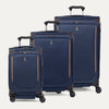 A set of three blue softside spinner suitcases, including a carry-on, medium, and large sizes on a white background