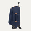 Side view of blue suitcase with handle and wheels on a white a background
