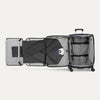 Open suitcase with fold out suiter and clothes on a white background