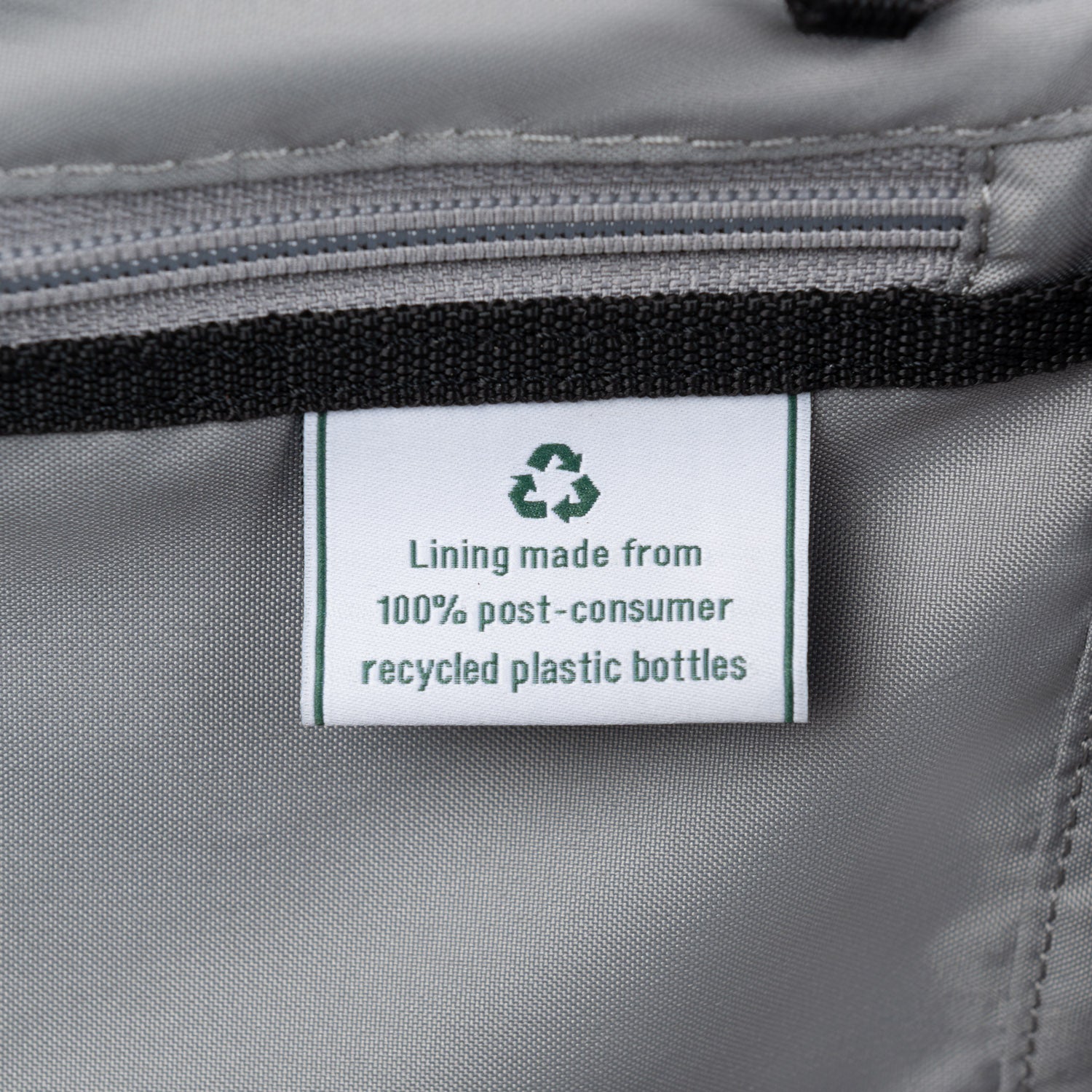 Close-up of label indicating lining made from 100% post-consumer recycled plastic bottles.