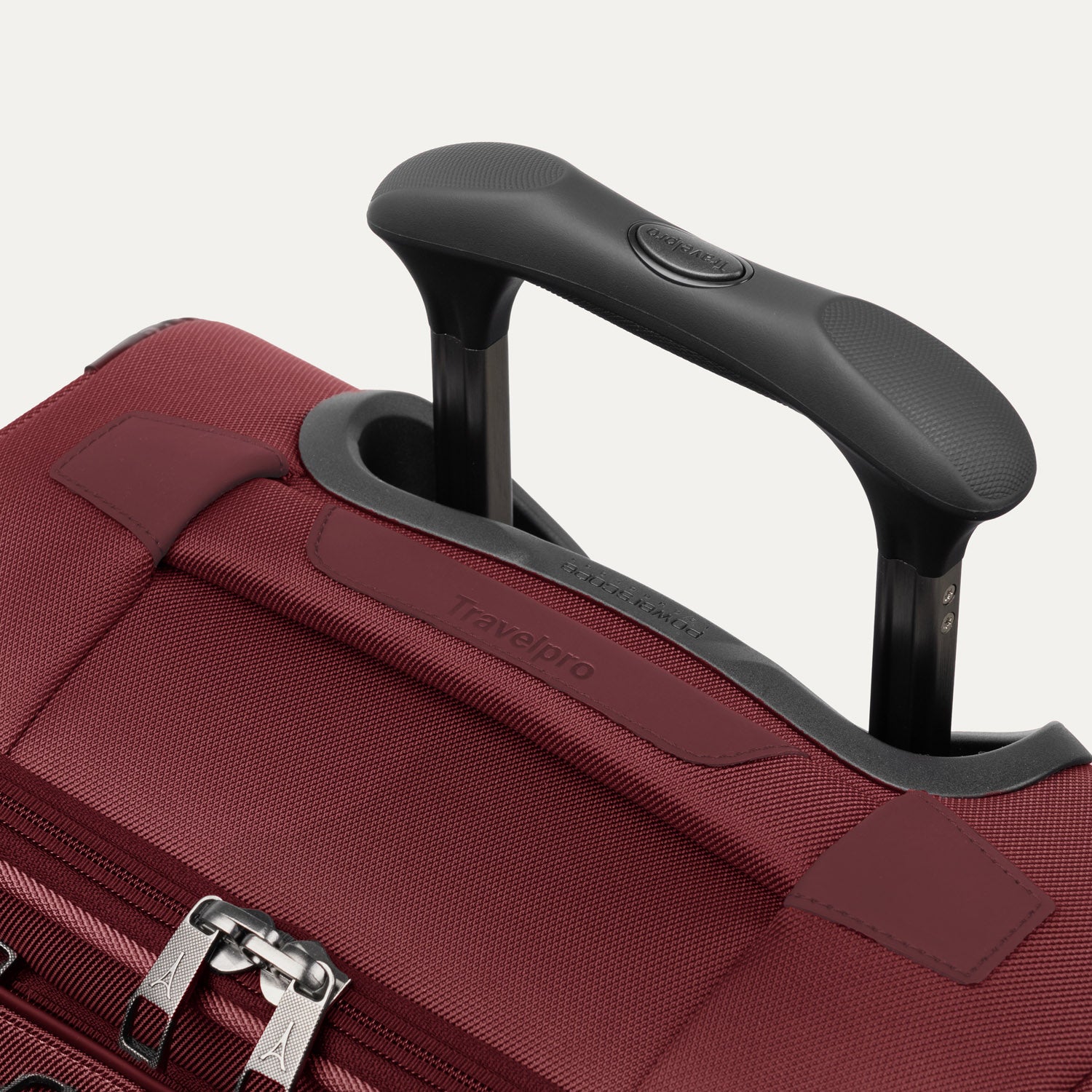 Close-up of the PowerScope Lite handle system and top carry handle on the Crew™ Classic Spinner in Rosewood Red.