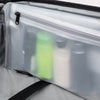 Clear interior view of suitcase with translucent zippered pouch holding upright travel-size toiletry bottles.