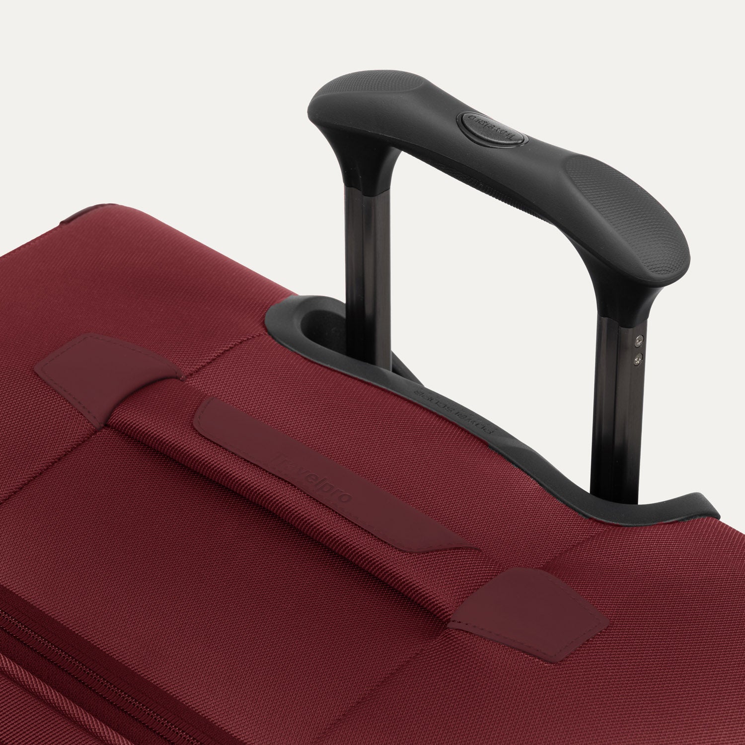 Close-up of the PowerScope Lite handle system and top carry handle on the Crew™ Classic Spinner in Rosewood Red.