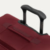 Close-up of the PowerScope Lite handle system and top carry handle on the Crew™ Classic Spinner in Rosewood Red.