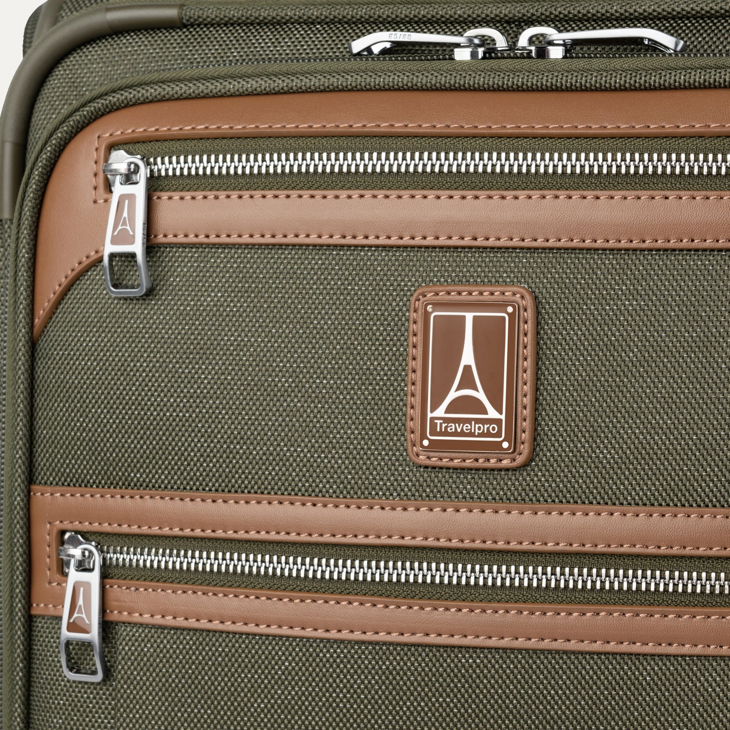 Close-up of a green suitcase with zippers and travelpro logo.