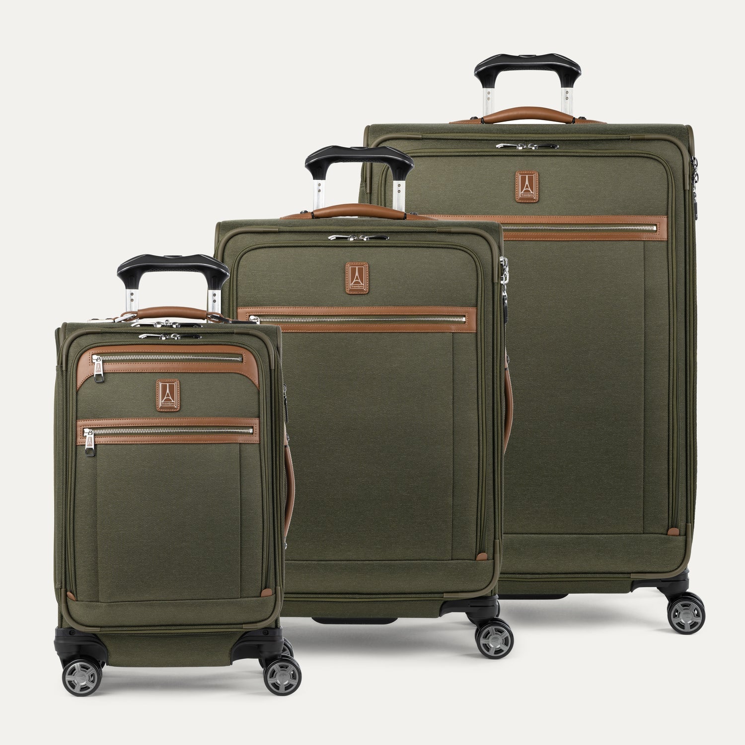A set of three green Platinum Elite spinners in carry-on and medium to large sizes, featuring leather accents and chrome zippers.