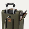Green suitcase with USB cable and other accessories on a white background