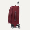 Side view of red suitcase with wheels and handle on a white background