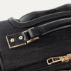 Close-up of a black suitcase handle and latch.
