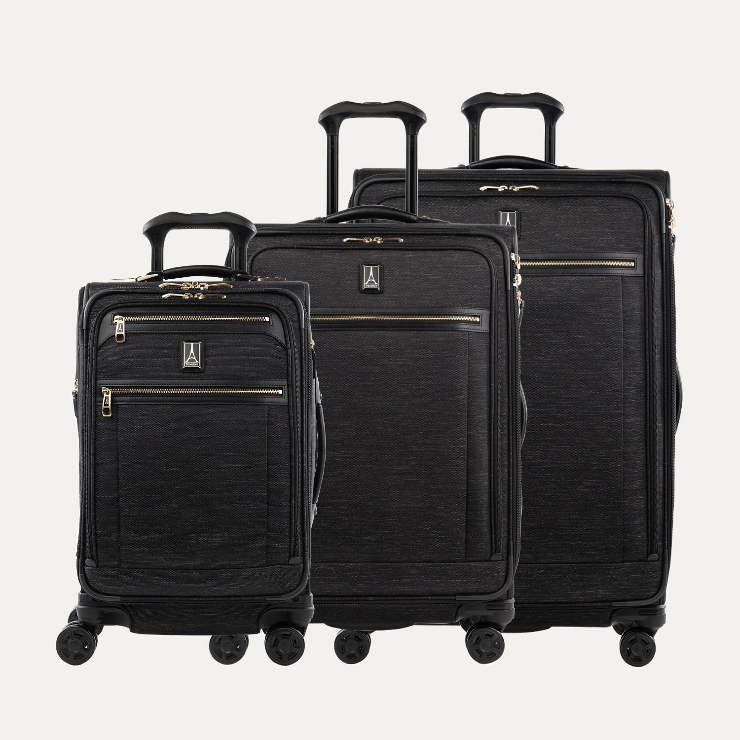 A set of three black suitcase a carry-on size and two larger sizes, with chrome zippers and leather accents.