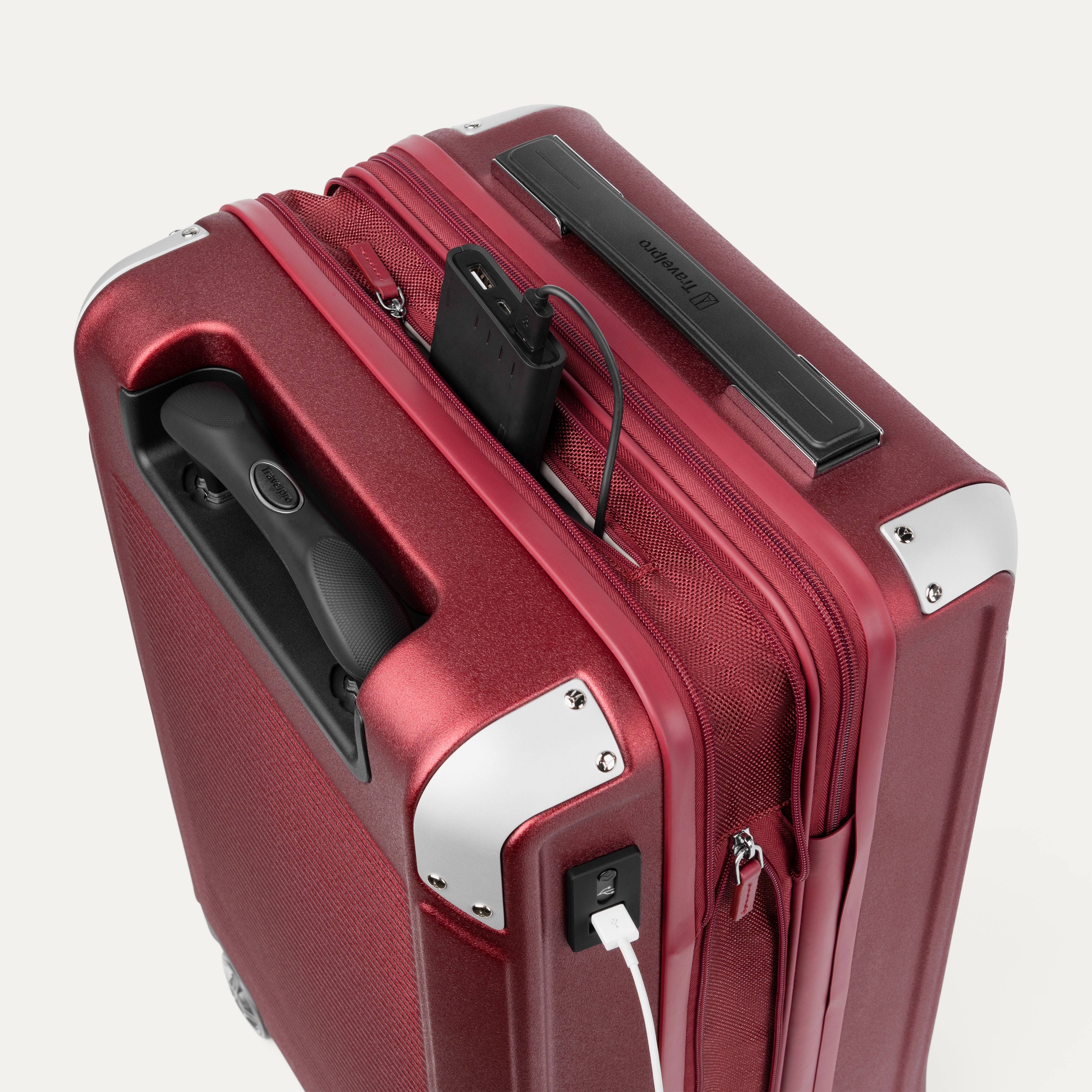 Close-up of a red suitcase with USB cable outlet on a white background.