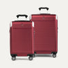 A set of two red hardside spinner suitcases, one carry-on and one medium check-in size, with the Travelpro logo on the top.