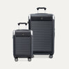 Two black suitcases of different sizes on a white background