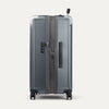 Gray suitcase with open door on a white background