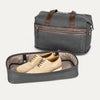 Grey weekender with detached shoe compartment on white background