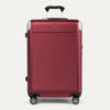 Front view of Travelpro Platinum® Elite Hardside Medium Check-In Expandable Spinner in Daring Red, featuring textured polycarbonate shell with chrome corner guards.