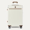 Front view of Travelpro Platinum® Elite Hardside Medium Check-In Expandable Spinner in Cream White, featuring grooved polycarbonate shell with chrome corner armor.