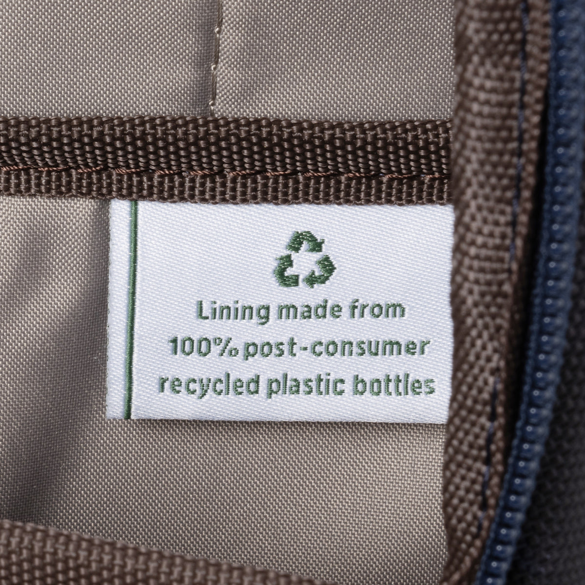 Close-up of interior label stating the lining is made from 100% post-consumer recycled plastic bottles.