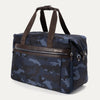 Platinum® Elite Soft Duffel in Camouflage, shown at an angle to highlight its structured shape, dual top handles, side attachment points, and front zippered pocket with leather trim.