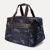 Expanded Platinum® Elite Soft Duffel in Camouflage, shown at an angle to highlight its structured shape, dual top handles, side attachment points, and front zippered pocket with leather trim.