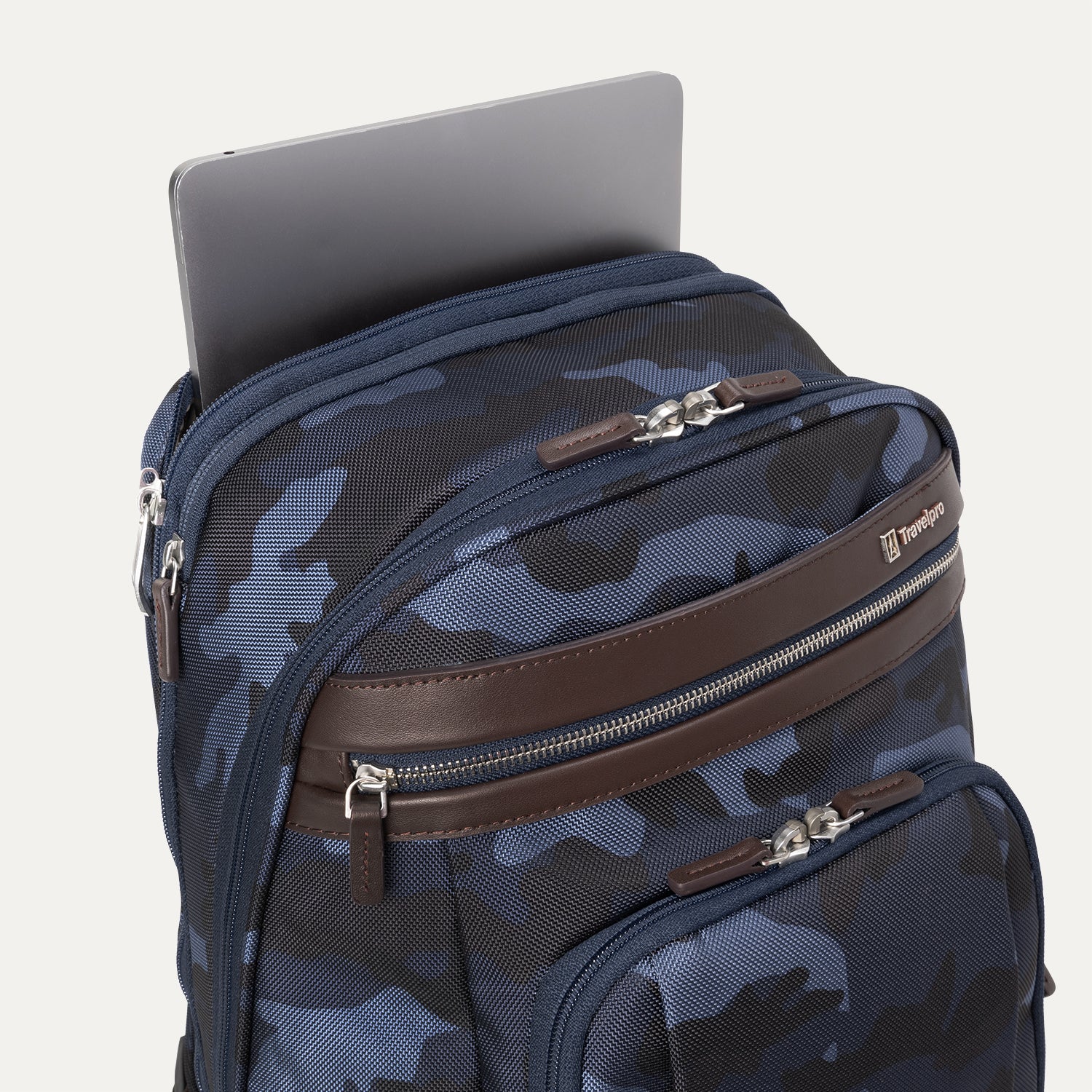 **Alt text:** Platinum® Elite Business Backpack in camouflage, shown with a laptop partially inserted into its padded top compartment.