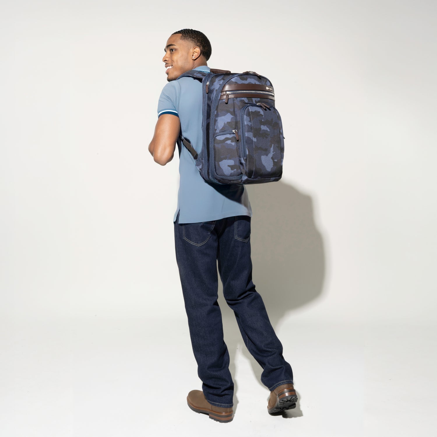 Man carrying the Platinum® Elite Business Backpack in Camouflage