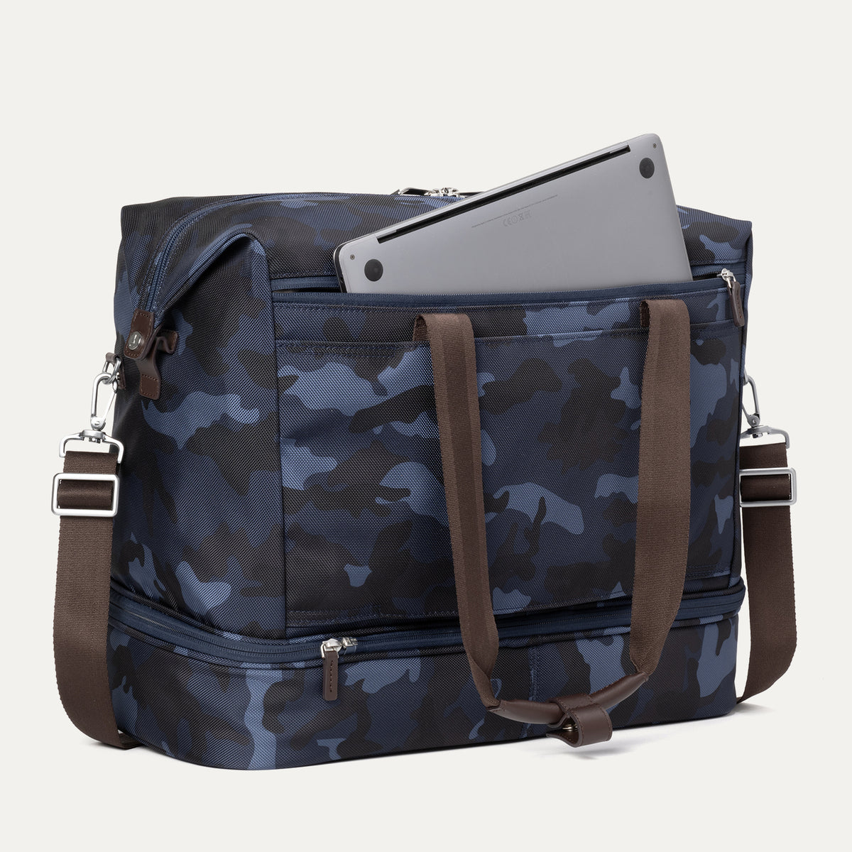 Rear view of Travelpro Platinum Elite Drop-Bottom Weekender in Navy Camouflage with laptop in zippered back pocket and detachable strap.