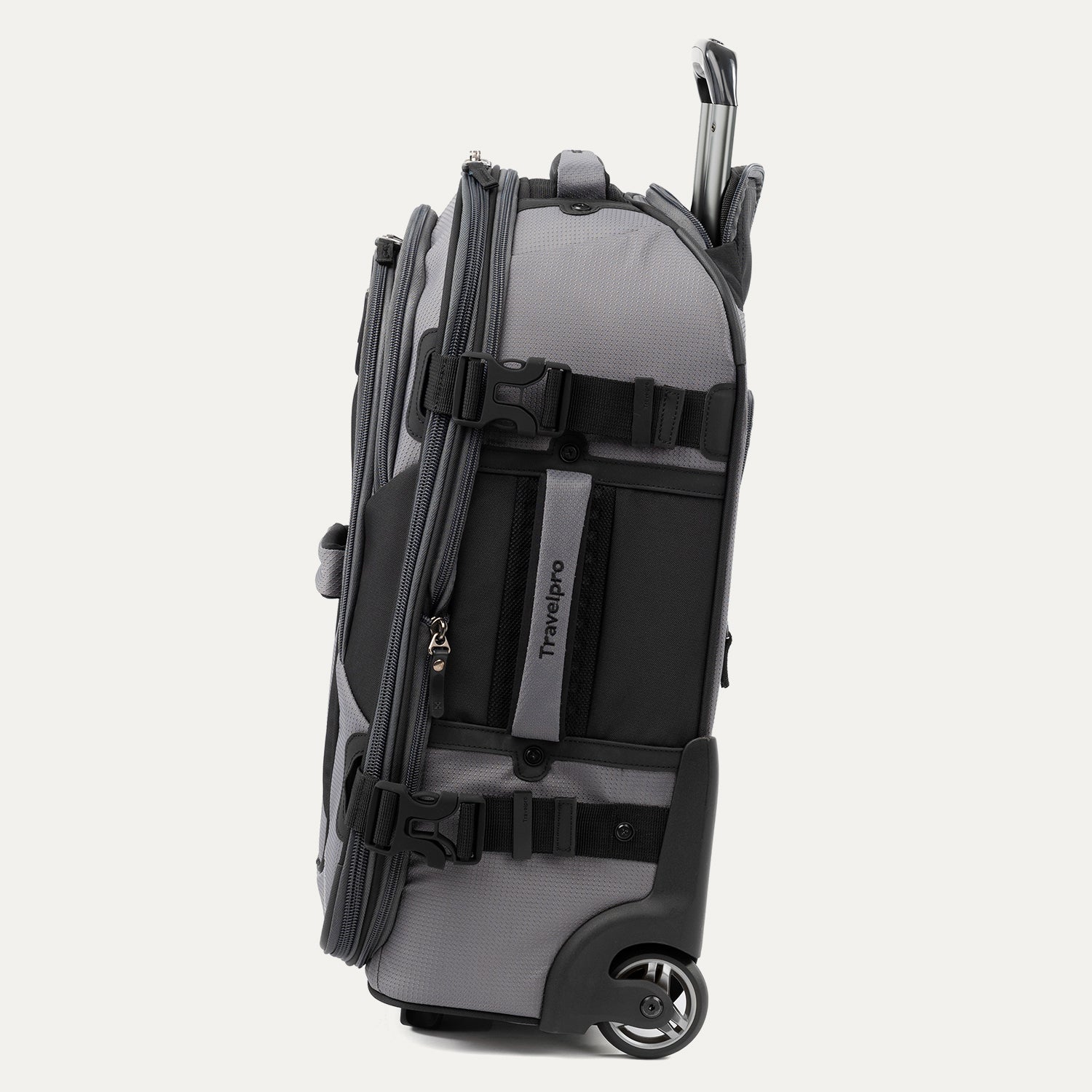 Side view of gray and black Bold™ by Travelpro® Rollaboard® showing compression straps, wheel housing, and telescoping handle.