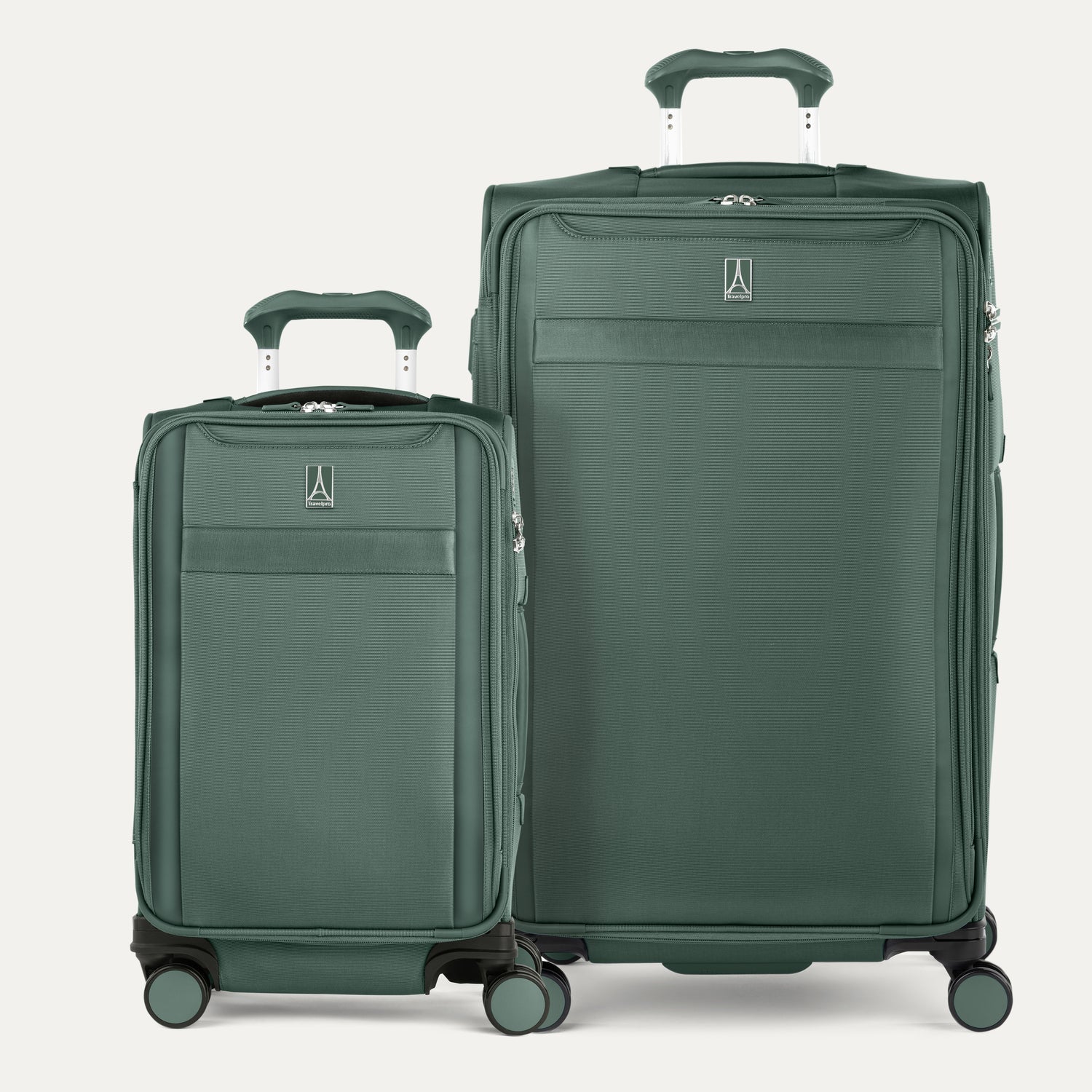 Two green suitcases of different sizes on a white background