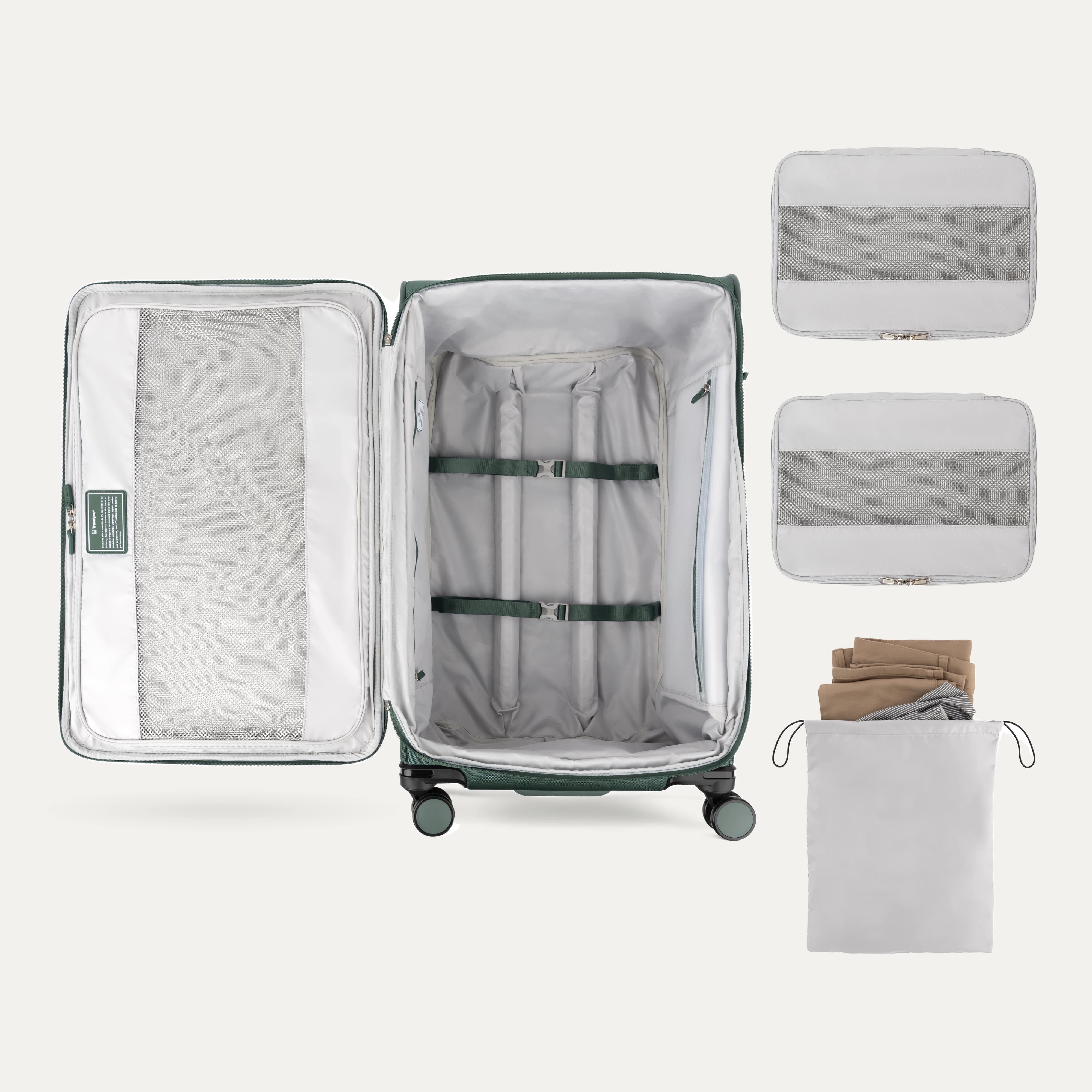Open suitcase with packing accessories on a white background