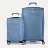 Two blue suitcases of different sizes on a white background
